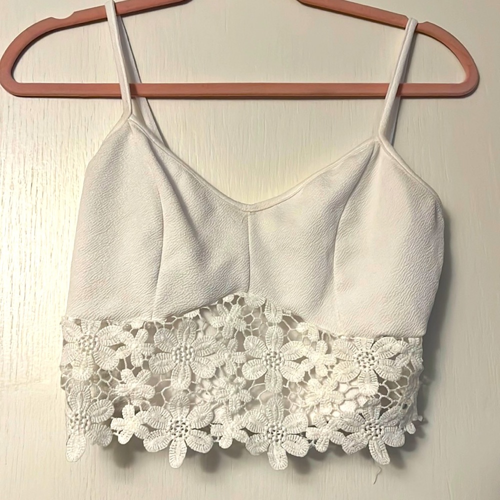 White Crop Top. With lace at the bottom. Women’s Size Medium.